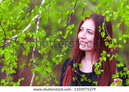young woman in birch leaves
