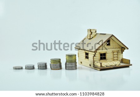 House invest concept with stacked coins isolated on white background. Financial/investment concept.