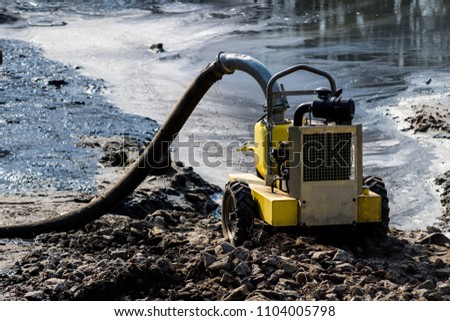 Photo of yellow pump for pumping out water