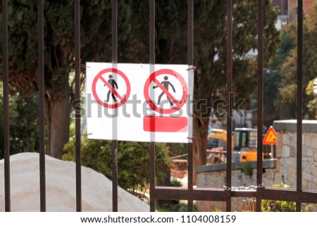 Sign of authorized personnel only at construction site. Red, black and white restricted area, Authorized Personnel Only warning sign on fence. Banned access to not worker at construction site.