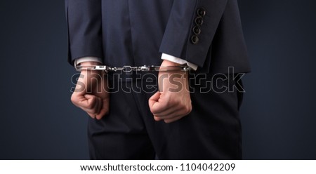 Close now arrested men hand with dark background and handcuffs Royalty-Free Stock Photo #1104042209