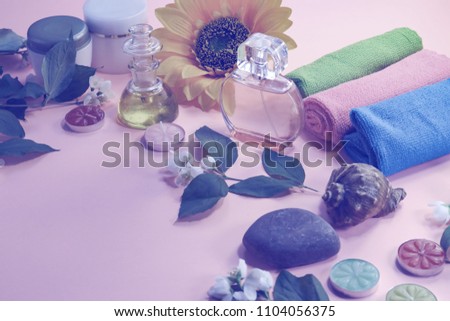 Beauty background with cosmetic products, bottle of perfume, leaves and jasmine blossom on toned  background. spa.  top view, flat lay. desktop, copy space.