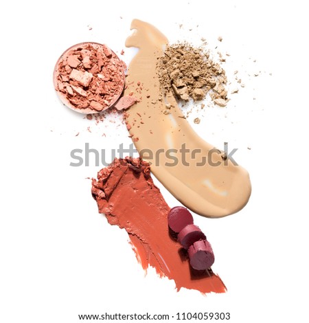 Creative concept photo of cosmetics swatches beauty products lipstick foundation cream round eyeshadow on white background.