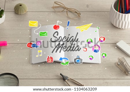 Notebook on the floor with instruments on the floor and social media, internet label on it