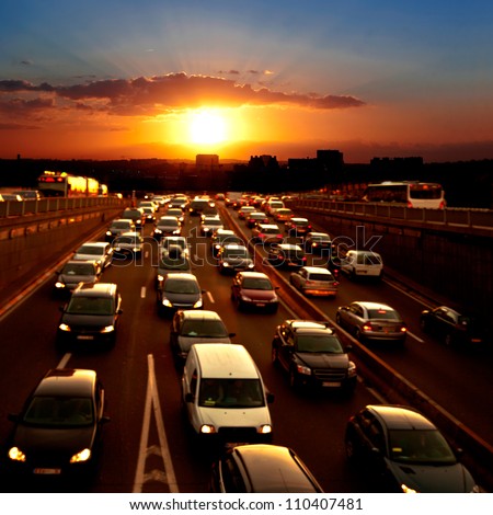 Evening traffic. The city lights. Car traffic against the sunset background. Royalty-Free Stock Photo #110407481