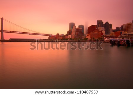 Bay Bridge and San Francisco panorama during sunset across the bay, USA