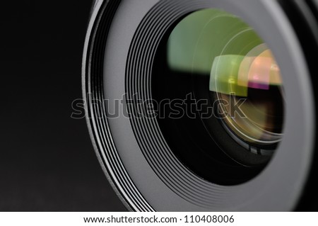 Camera lens close-up on black background Royalty-Free Stock Photo #110408006