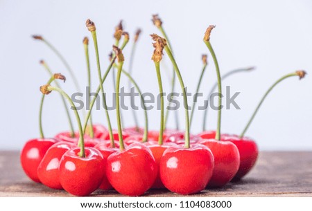 Red cherry fruits on wooden table top
