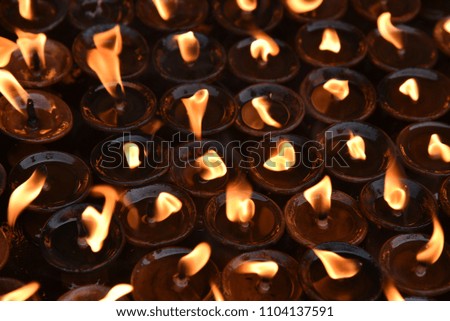Lighting prayer candles  in the buddha temple