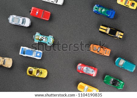 Colorful automotive toys. The apartment was lying, on a gray background
