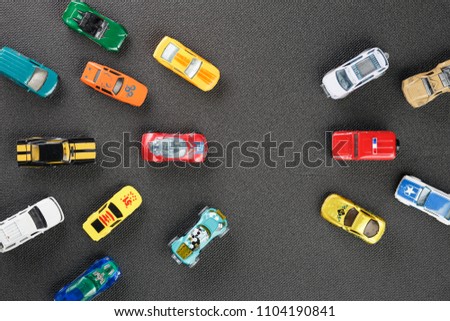Colorful automotive toys. The apartment was lying, on a gray background