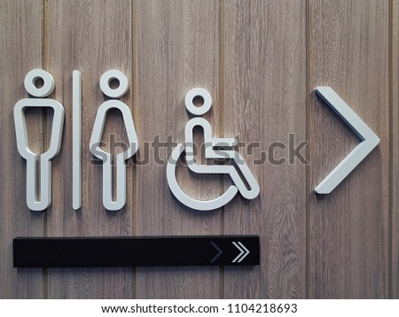 White Toilet Symbols on Wooden Plank Wall
