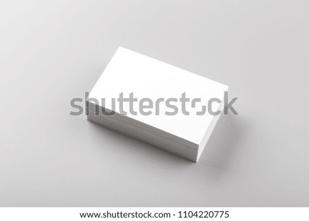 Photo of white business cards isolated on gray background. Template for branding identity. For graphic designers presentations and portfolios. Business Card isolated on gray. White business card mock-