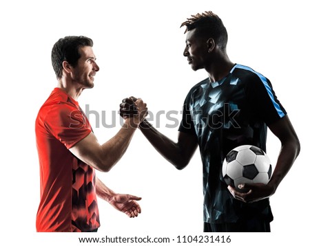 two soccer players men in studio silhouette isolated on white background Royalty-Free Stock Photo #1104231416
