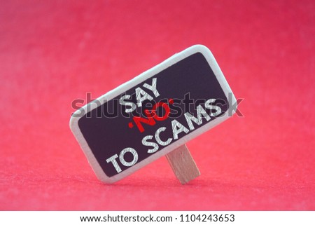wooden tag written say 'no' to scams over red background