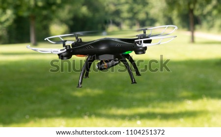 radio-controlled quadcopter with camera for video and photo shoot speedy orange-red racing on white background isolated