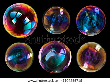soap bubbles isolated on black background . Royalty-Free Stock Photo #1104256715