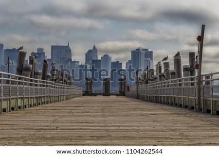 A view of a pier with buildings at background in Liberty Island, New York