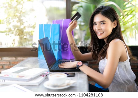 Young Asian woman holding credit card with laptop computer  ,Online shopping concept