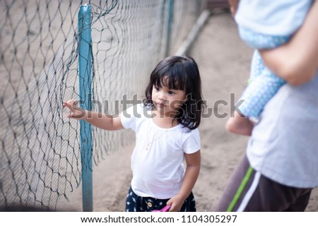 Cute little girl playing outdoor.Village kids playing outdoor.