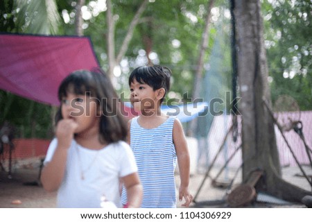 Cute Little boy and girl walking outdoor.Village kids playing outside house.Selective focus.