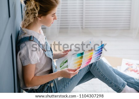 art painting hobby. creative drawing leisure. girl looking through pictures and color swatches. talent inspiration creation and self expression concept