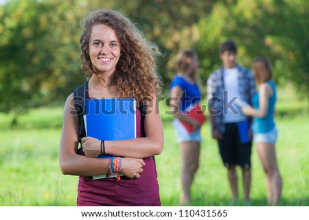 Young Female Student at Park with Other Friends