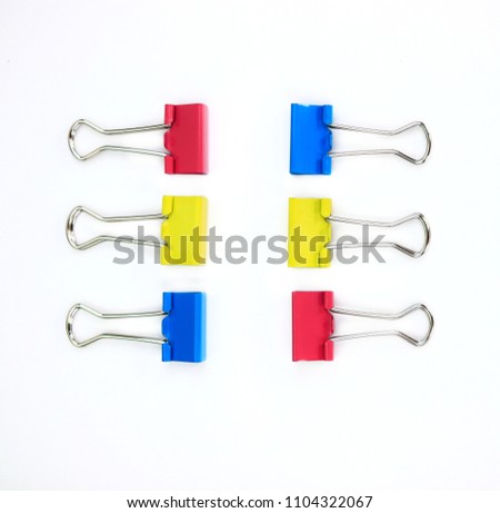 Colorful of paper clamps, collection of education office supplies top view, closeup, abstract texture background