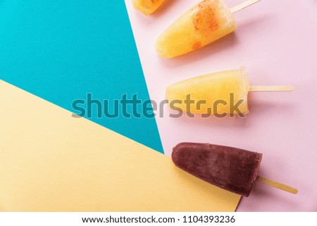 Colorful pineapple and berry popsicles background
