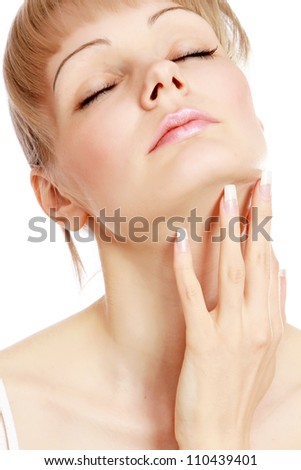 Close-up of pretty young woman touching her face