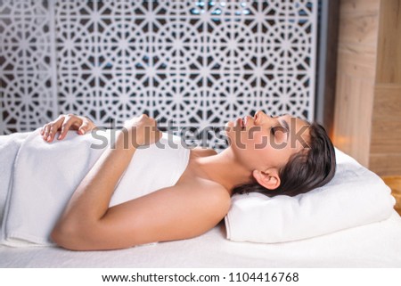 close up photo of lying tired woman after treatments in the resort. sleeping after massage