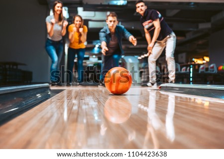 Friends having fun while bowling, selective focus