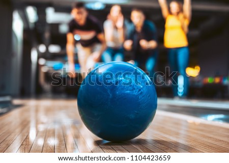 Friends having fun while bowling, selective focus