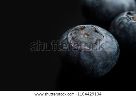 A closeup of blueberries on a black background