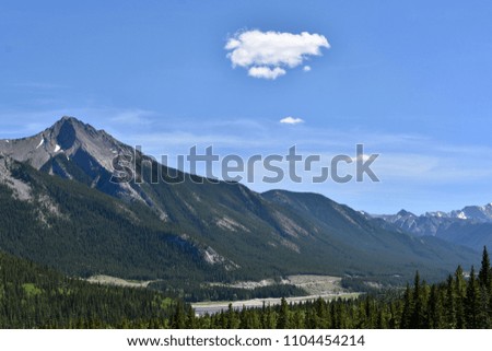 Gorgeous Canadian Rocky Mountains with a single cloud overhead (Kananaskis, Alberta)