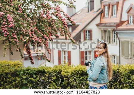 Young beautiful woman enjoying spring in the city, fashion girl wearing denim jacket. Image taken in Lausanne, Switzerland