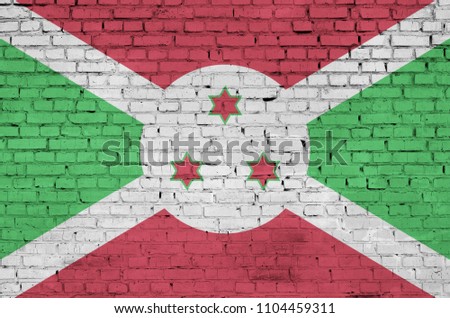 Burundi flag is painted onto an old brick wall