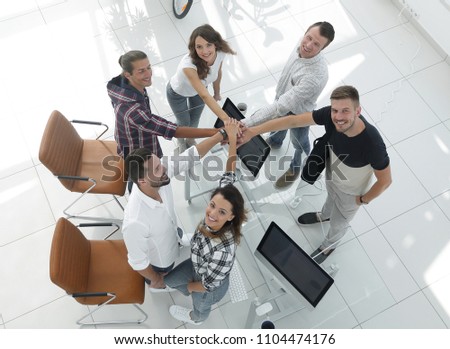 successful team with hands clasped togethe