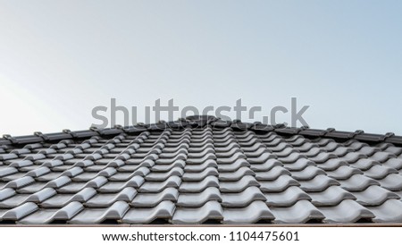 Dark brown ceramic tile roof. Copy space.