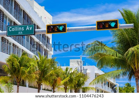 Miami Beach cityscape with art deco architecture and palm trees.