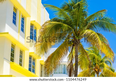Miami Beach cityscape with art deco architecture and palm trees.