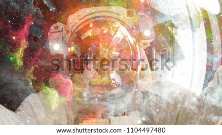 Astronaut in outer space. Science fiction art. Elements of this image furnished by NASA.