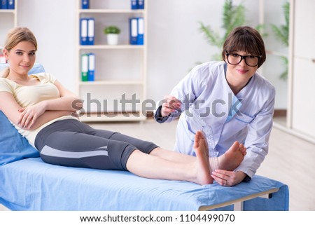 Doctor checking joint flexibility with goniometer