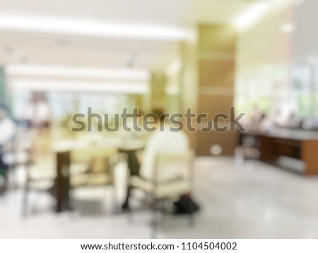blurred image of teamwork people concept.Young team of coworkers making great business discussion in modern coworking office and talking with partners while showing new startup idea monitor
