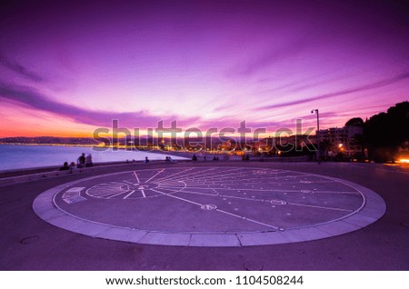 Unrecognized people enjoying the sunset from the Large Sun Dial Installation on Sidewalk "Quai Rauba Capeu" in the promenade des anglais at sunset, Nice, france