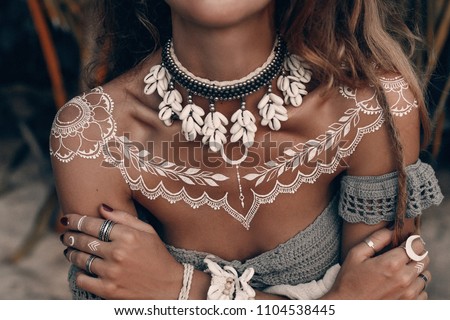 close up boho woman with traditional ornament outdoors at sunset