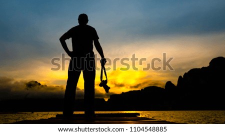 Silhouette of a photographer on beautiful sunset