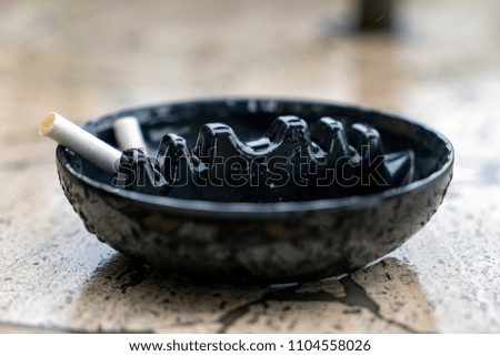 Cigarette in Black Tray on Table