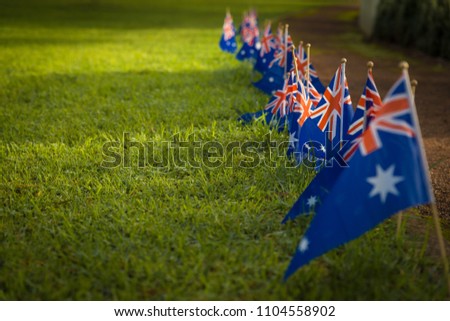 Line of Australian flags along path way in the park. National symbol of celebration  Australia or ANZAC Day