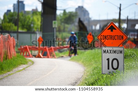 Bike path under construction warning signs with cyclist